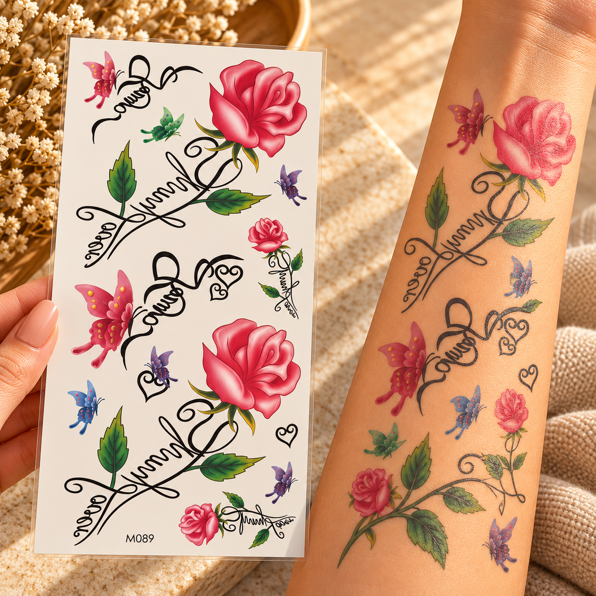 Pink rose and colourful butterfly temporary tattoo sheet with script lettering and hearts, shown applied to an arm