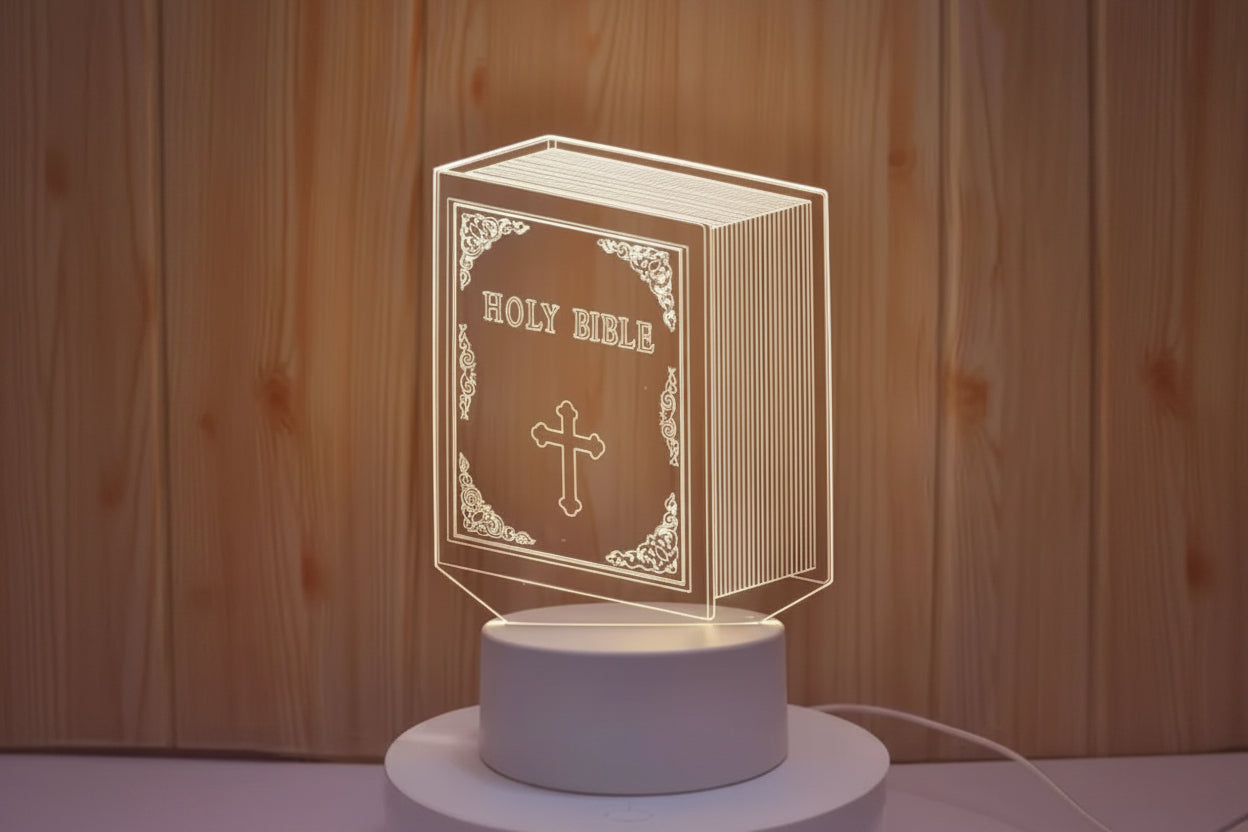 3D LED lamp shaped like a Holy Bible with a cross on a wooden background