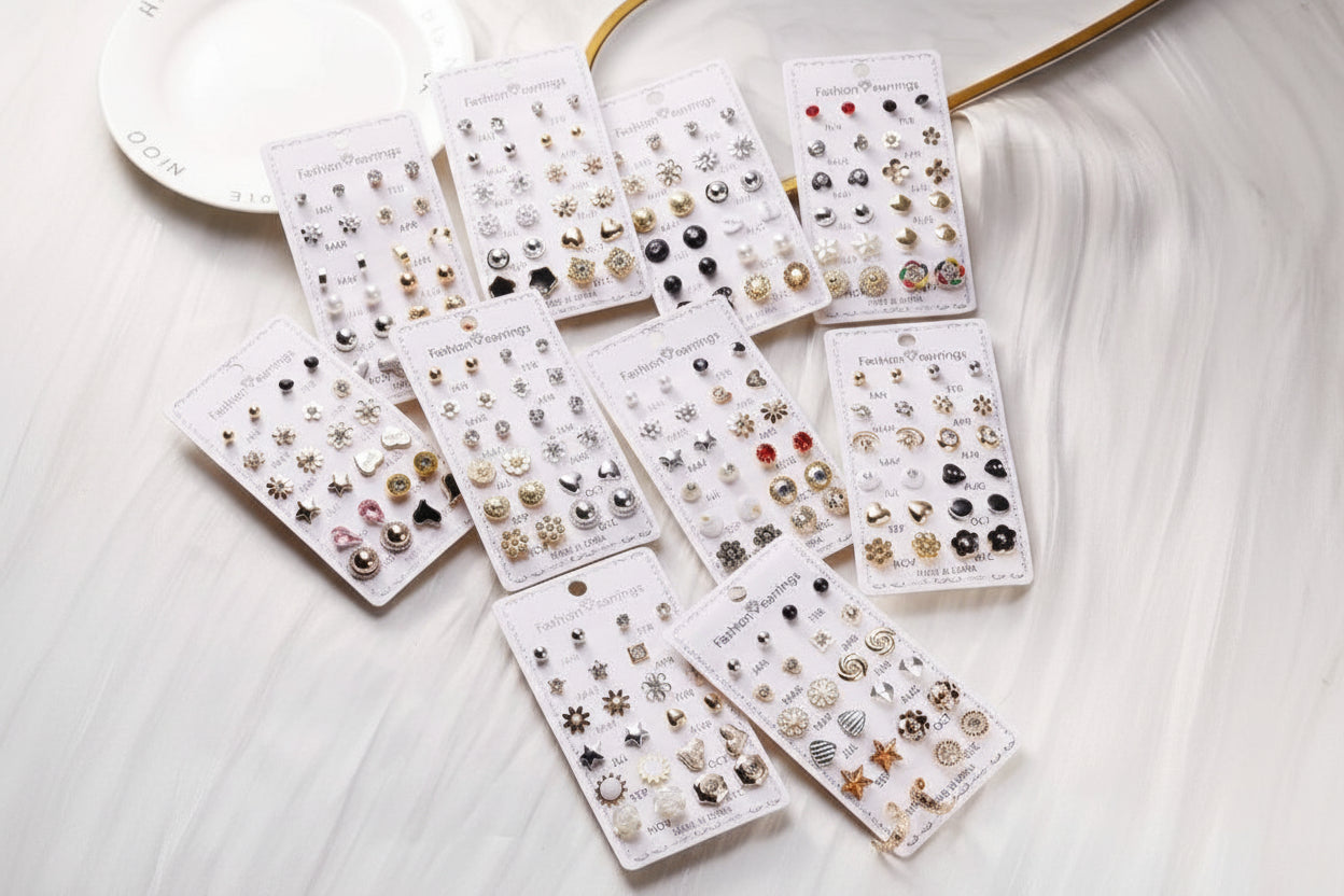 Assorted earring sets on display cards on a white surface