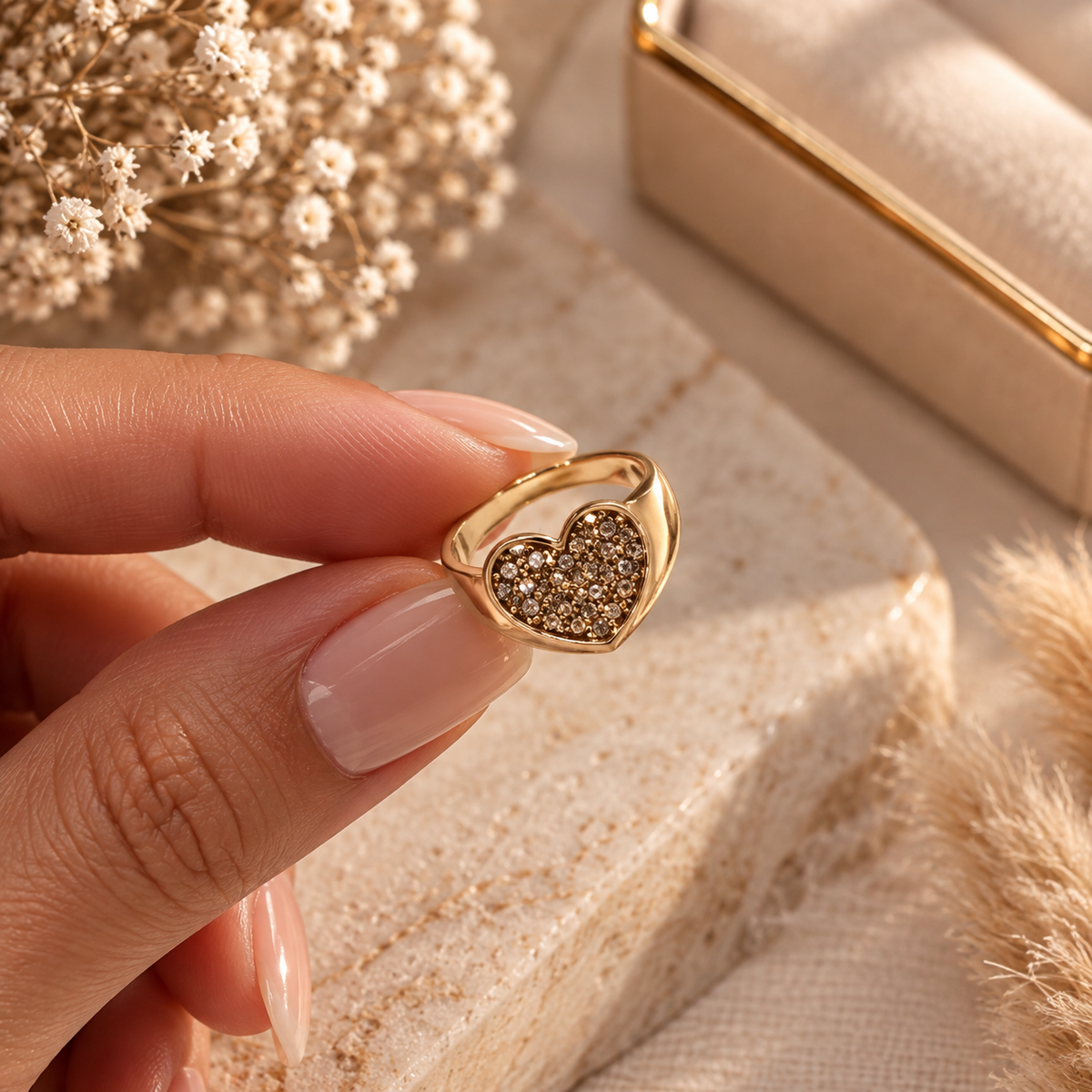 Gold-tone heart-shaped ring with sparkling crystal details