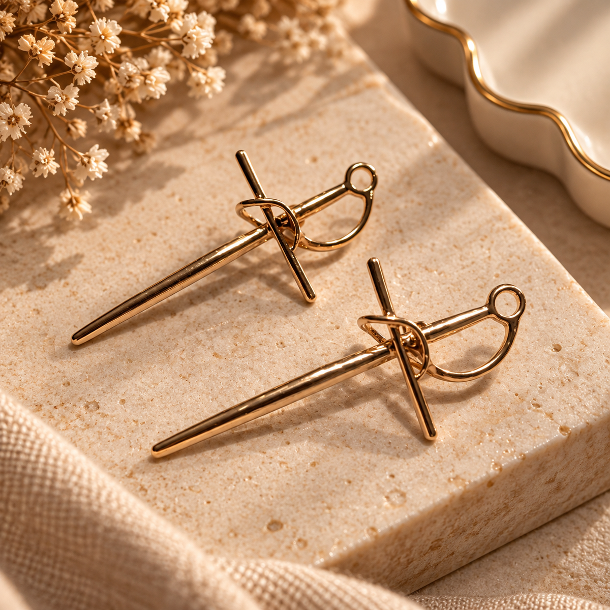 Pair of modern gold-tone bow-inspired drop earrings
