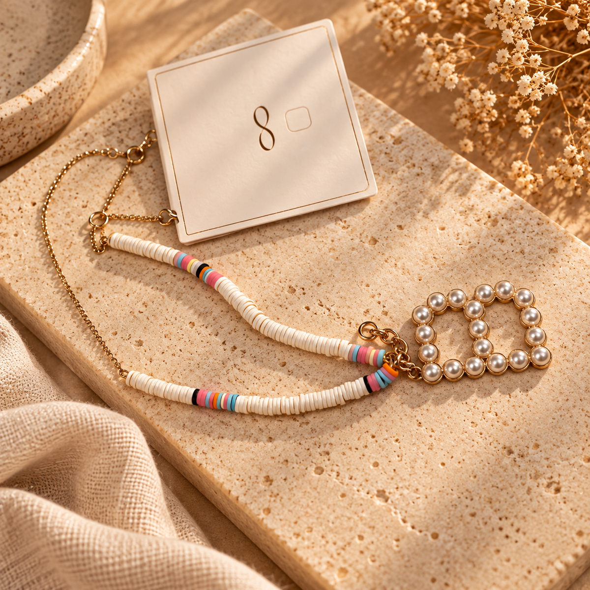 Colourful beaded necklace with gold-tone chain and pearl-style heart charm