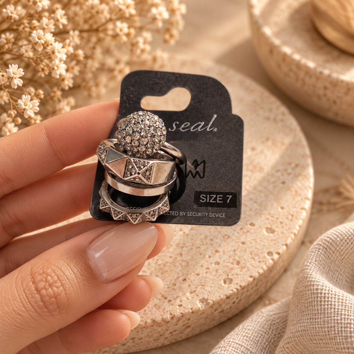 Silver-tone statement ring set with sparkling and geometric designs in size 7