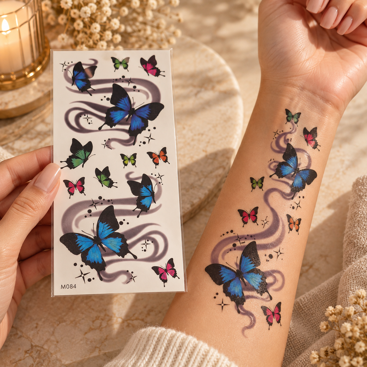 Blue and pink butterfly temporary tattoo sheet shown applied to a forearm