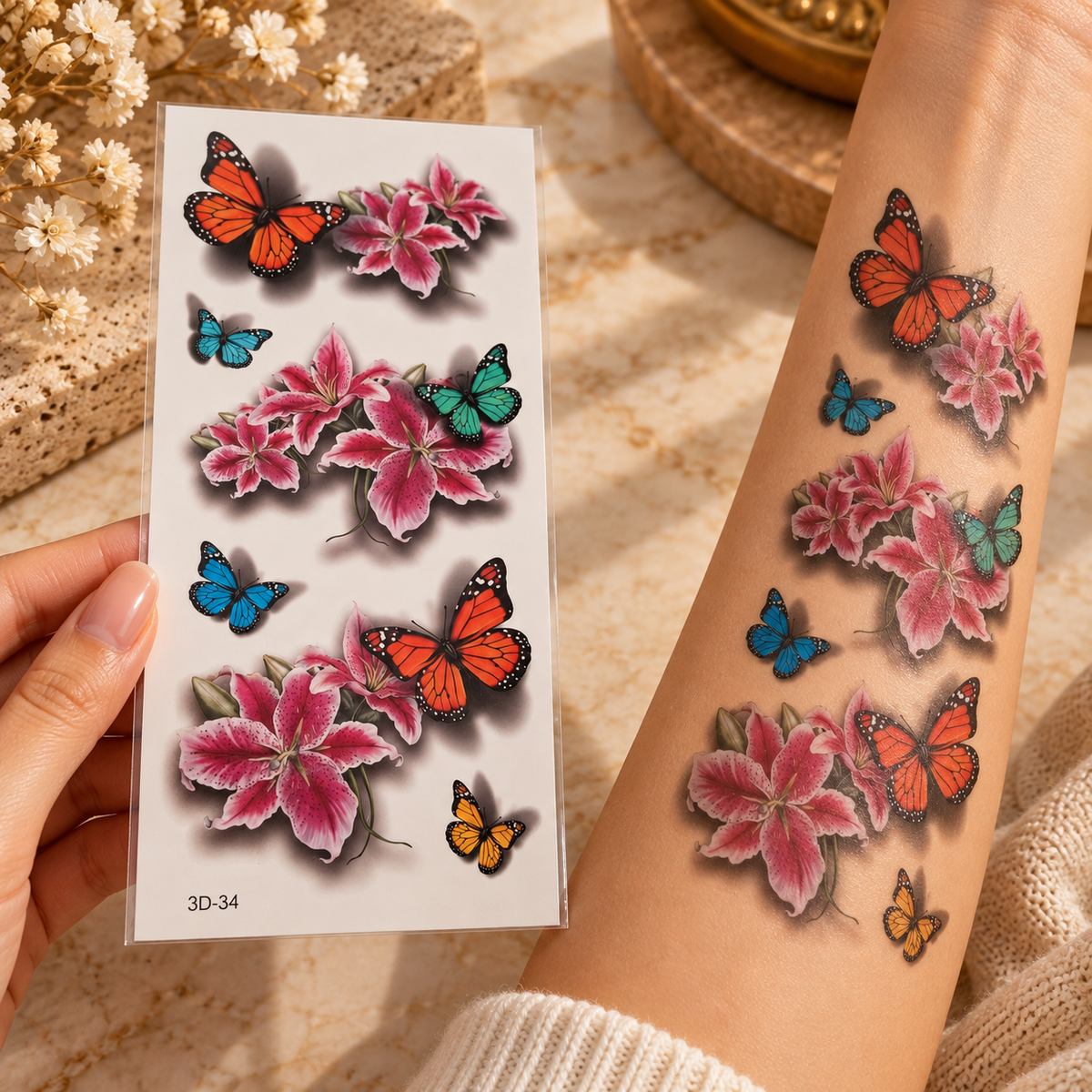 3D butterfly and pink lily flower temporary tattoo sheet shown applied to a forearm