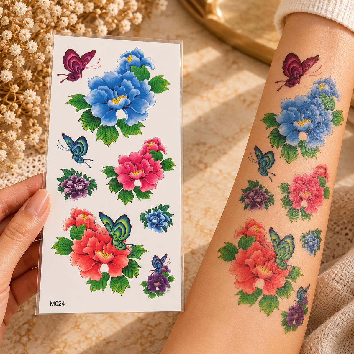 Colourful floral and butterfly temporary tattoo sheet shown applied to a forearm