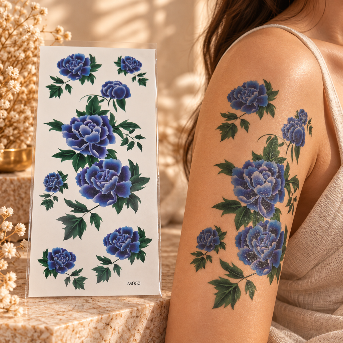 Large blue peony temporary tattoo sheet shown applied to a shoulder and upper arm
