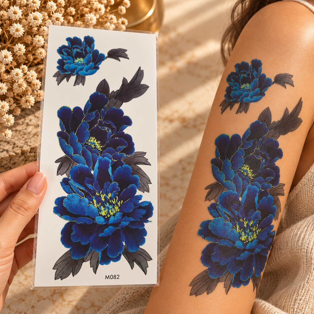 Large deep blue floral temporary tattoo sheet shown applied to a leg