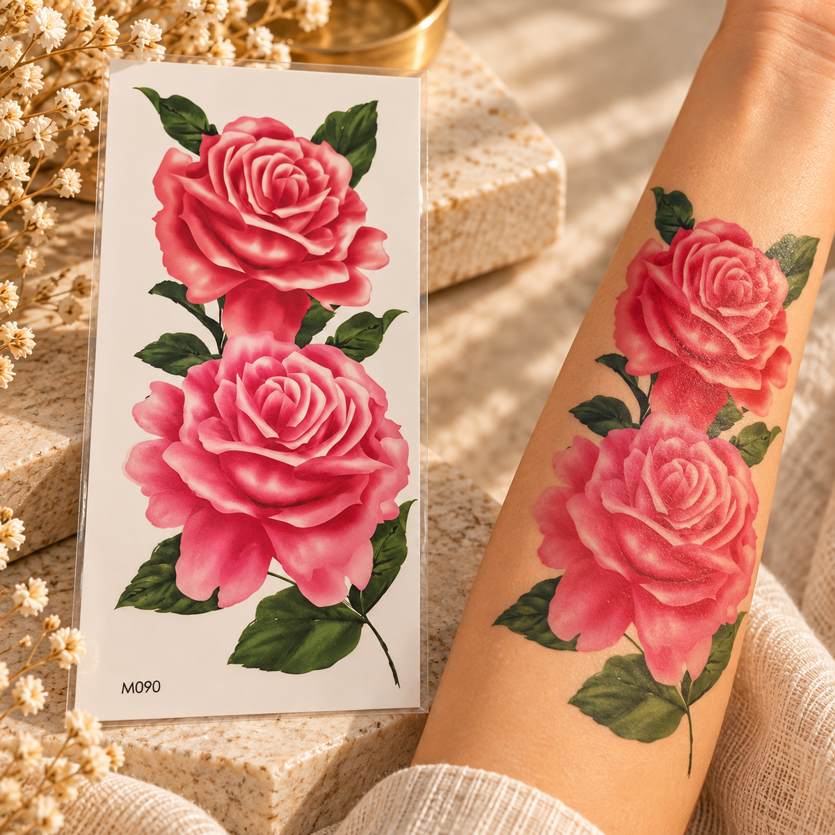 Large pink rose temporary tattoo sheet shown applied to a forearm
