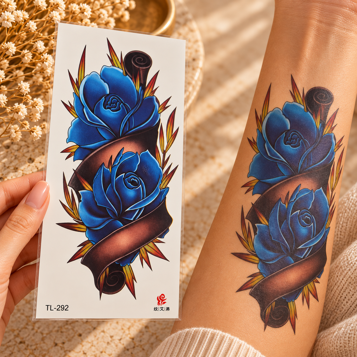 Large blue rose and ribbon temporary tattoo sheet shown applied to a forearm