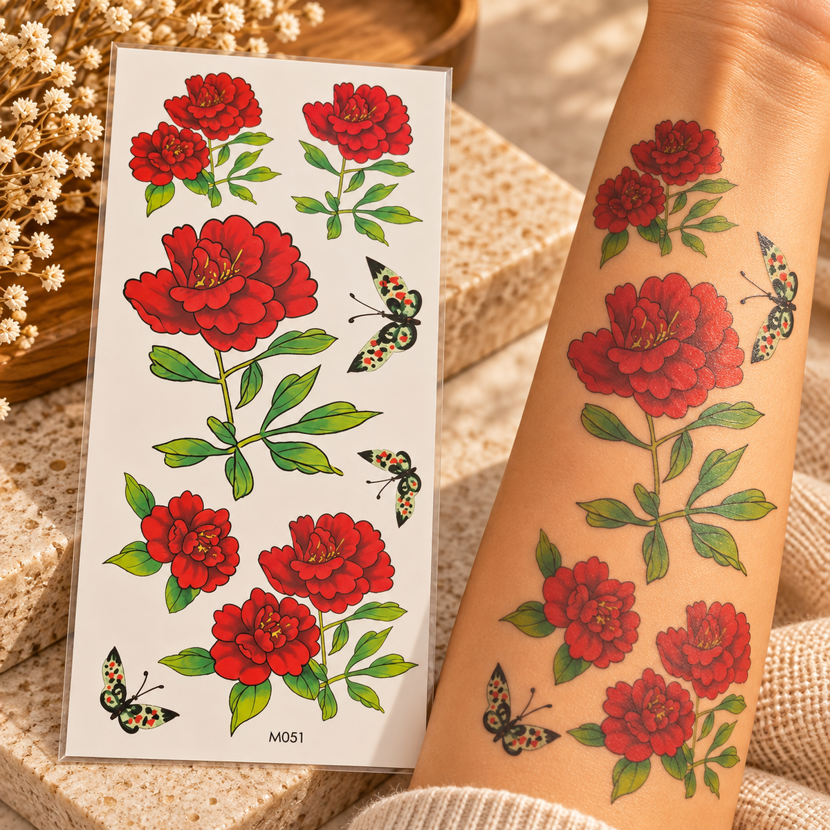 Red floral and butterfly temporary tattoo stickers on a sheet and shown applied to an arm
