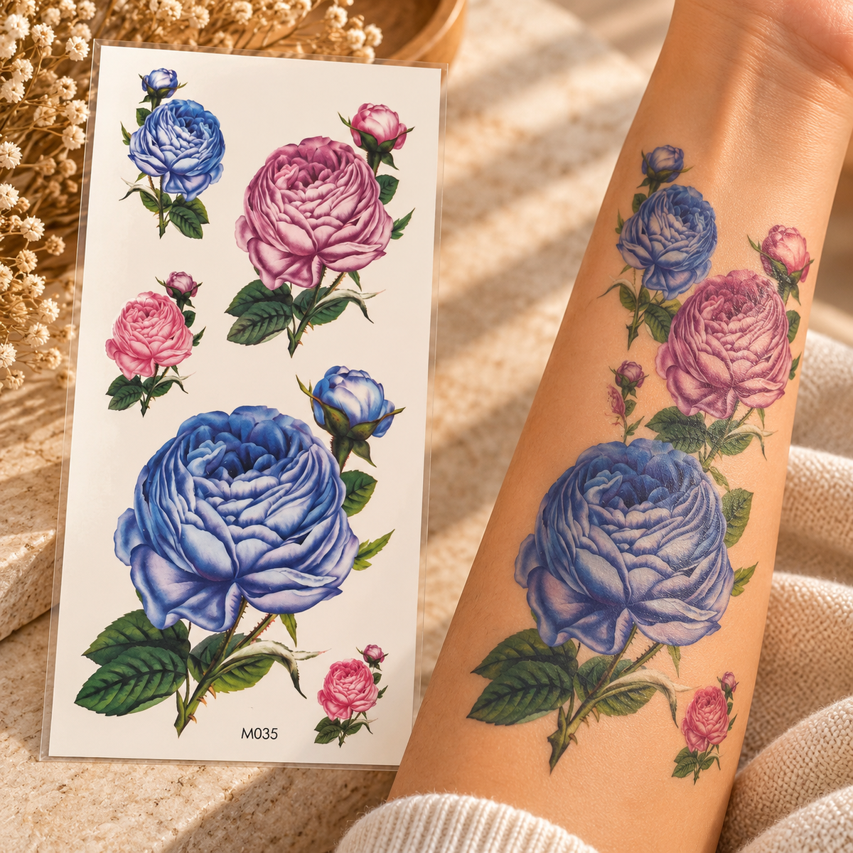 Blue and pink vintage rose temporary tattoo sticker sheet with rosebuds shown beside an arm wearing the designs