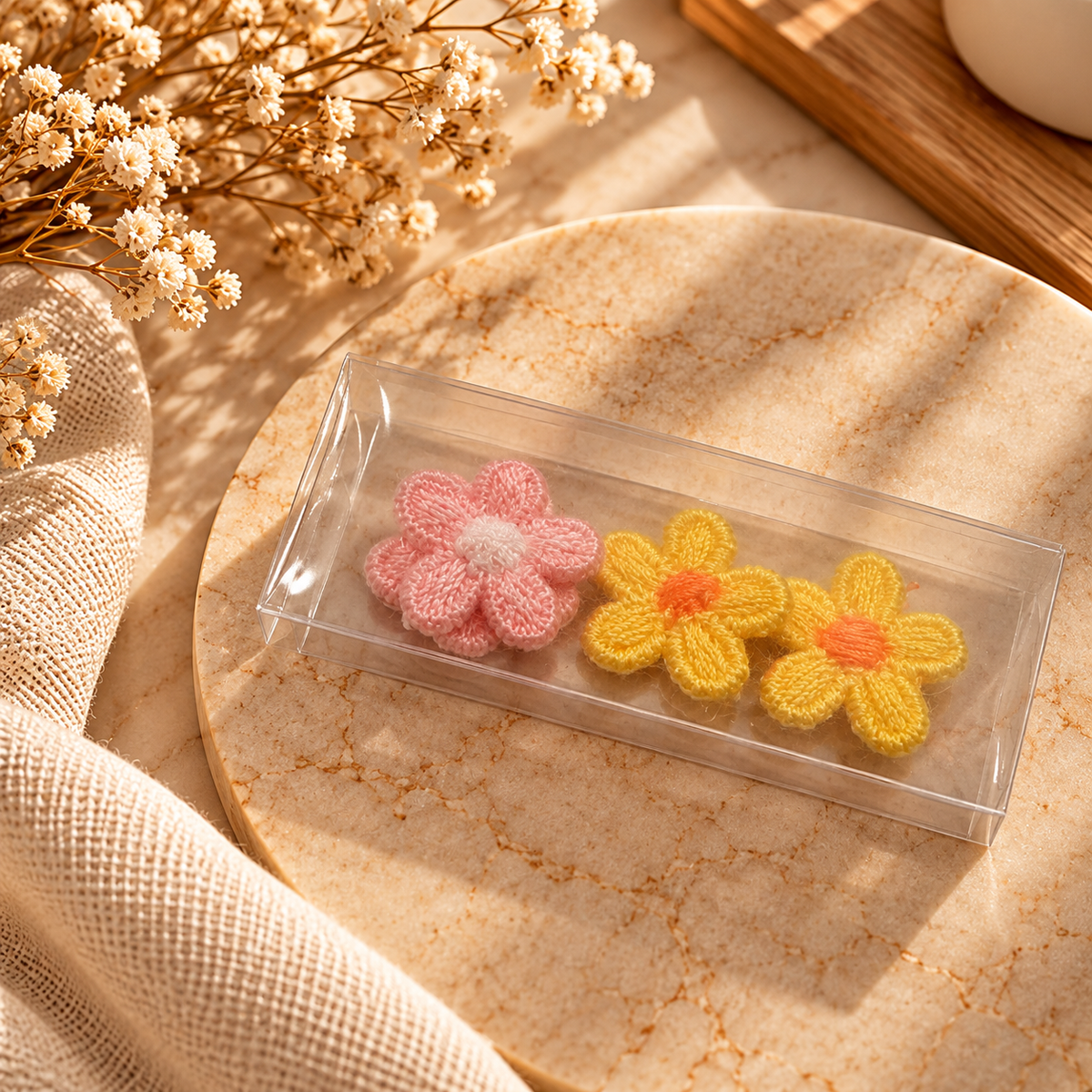 Assorted pastel crochet-style embroidered flower embellishments in pink and yellow