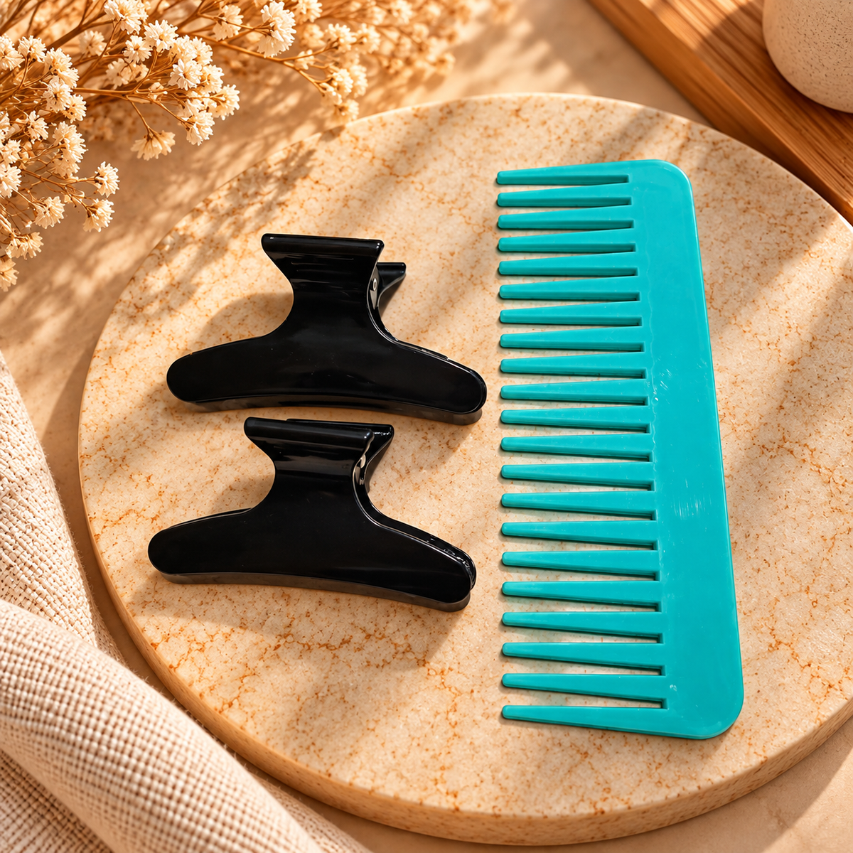 Wide-tooth teal comb with two black claw clips