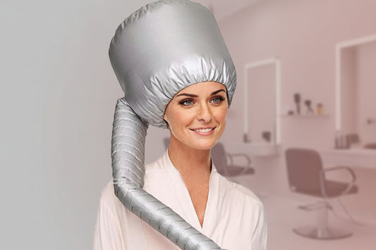Woman wearing a silver hair dryer bonnet with a white background
