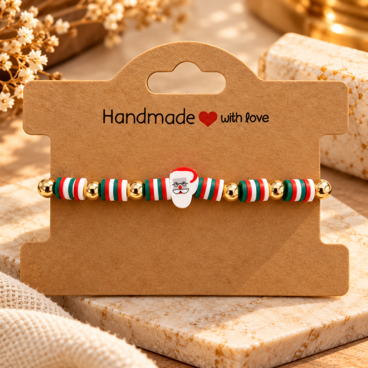 Handmade Santa bracelet with red, green and white beads and gold-tone accents on a kraft display card.