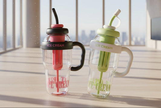 Two transparent water bottles with colorful straws on a wooden surface with a cityscape view.
