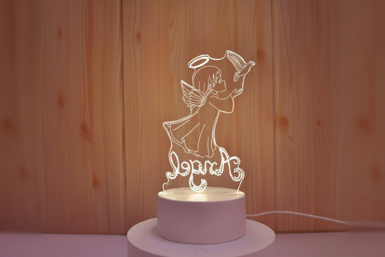 Angel-shaped night light with 'Love' text on a wooden background