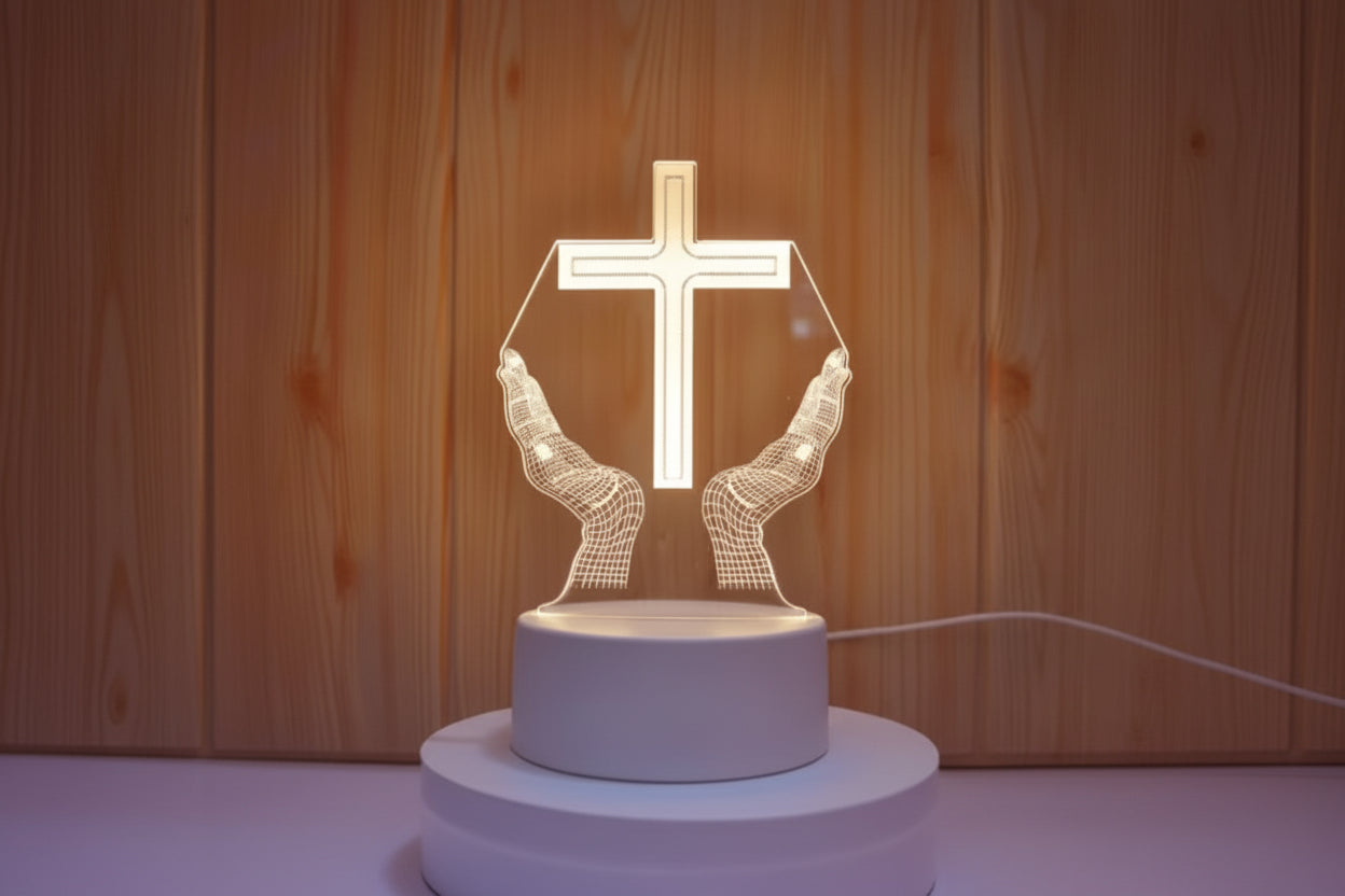 Decorative lamp with hands holding a cross against a wooden background