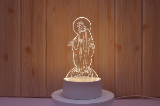 Decorative night light shaped like a religious figure on a wooden background