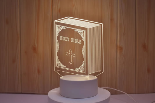 3D LED lamp shaped like a Holy Bible with a cross on a wooden background